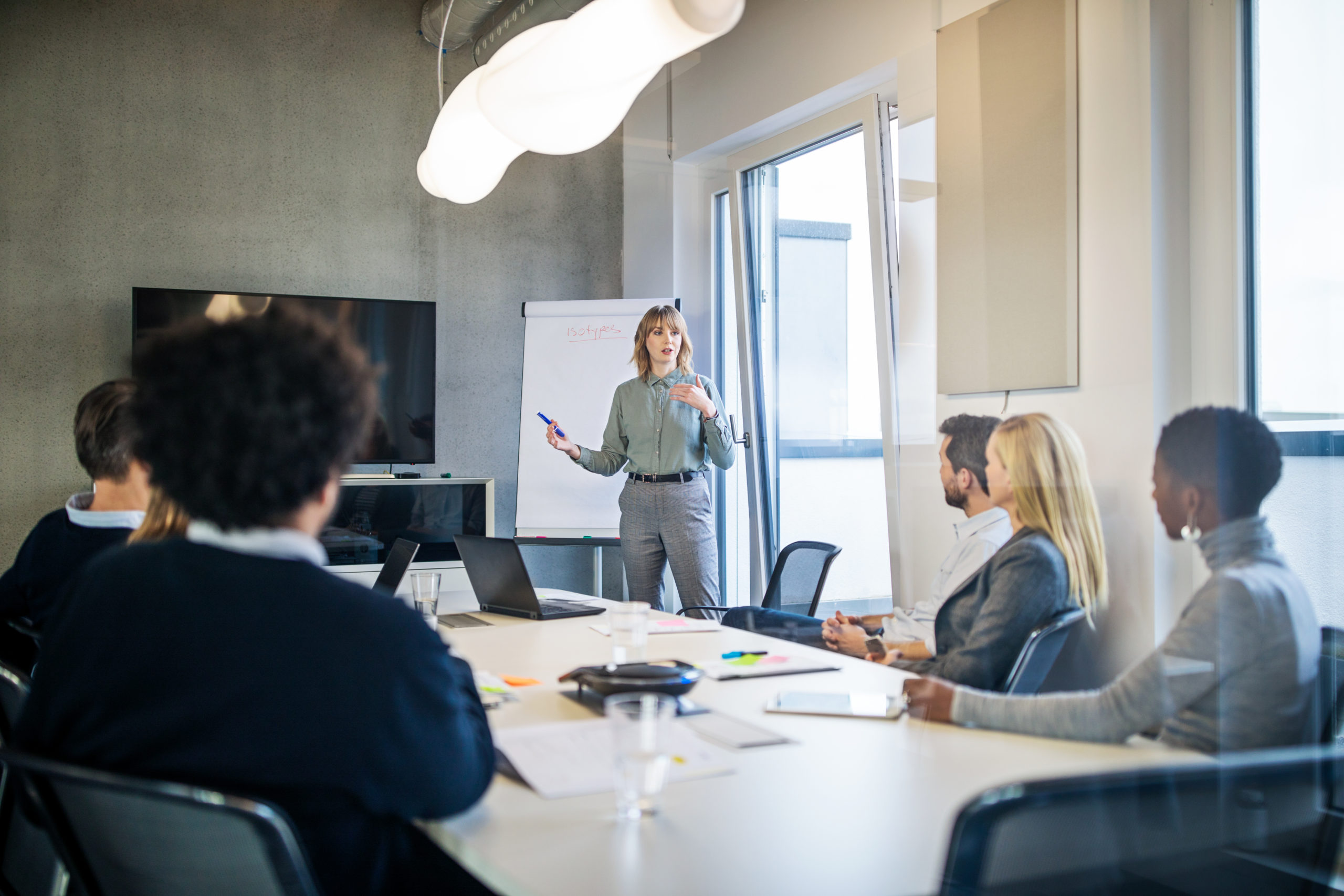 Businesswoman addressing a meeting around board table