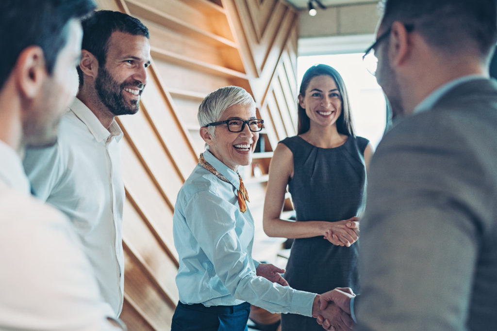 Group of business persons handshake in the office