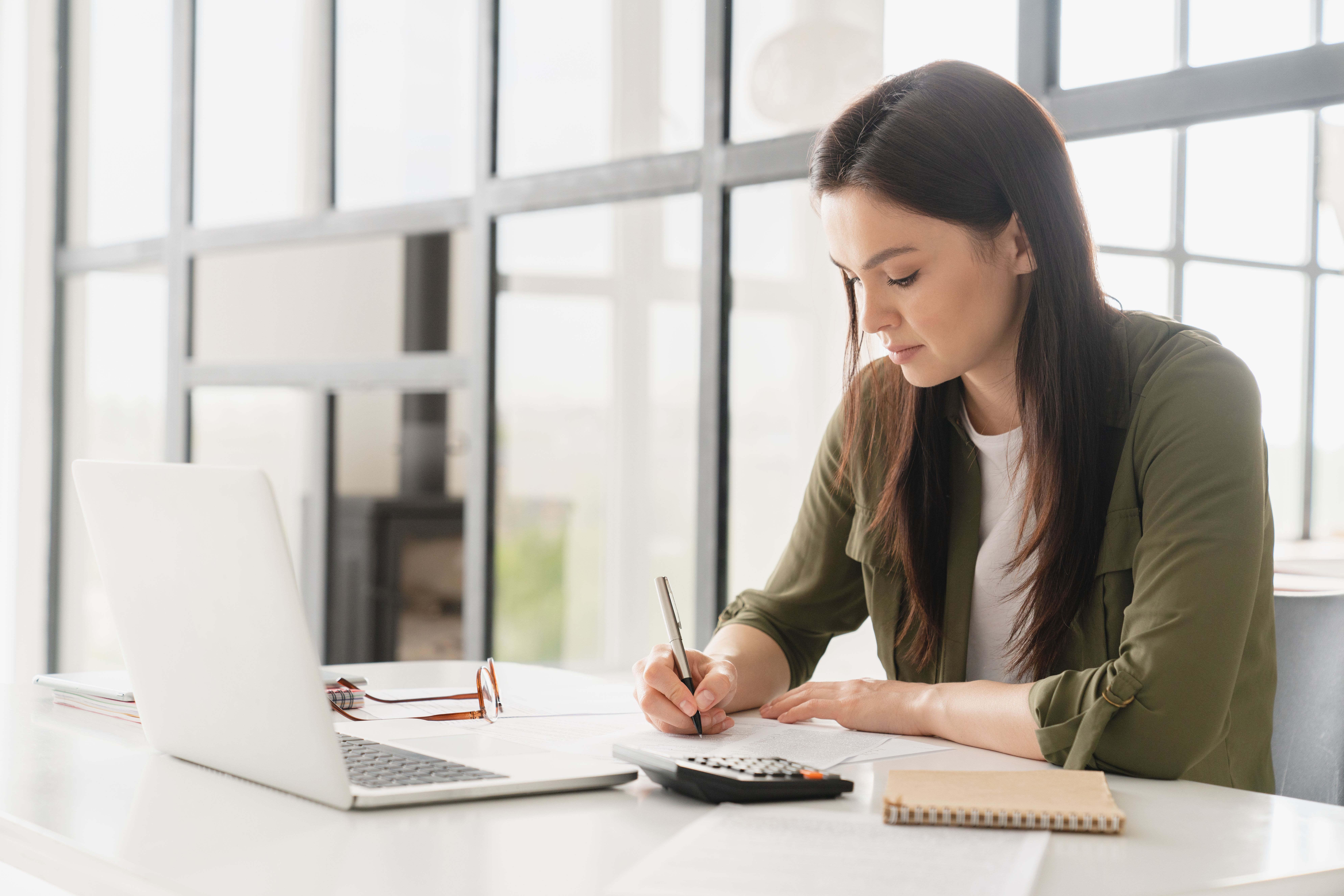 Busy young businesswoman female freelancer boss CEO working on project startup in office. Student tutor doing homework using laptop remotely. E-learning concept