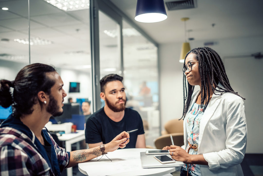 young business people discussing in office talking about HR compliance