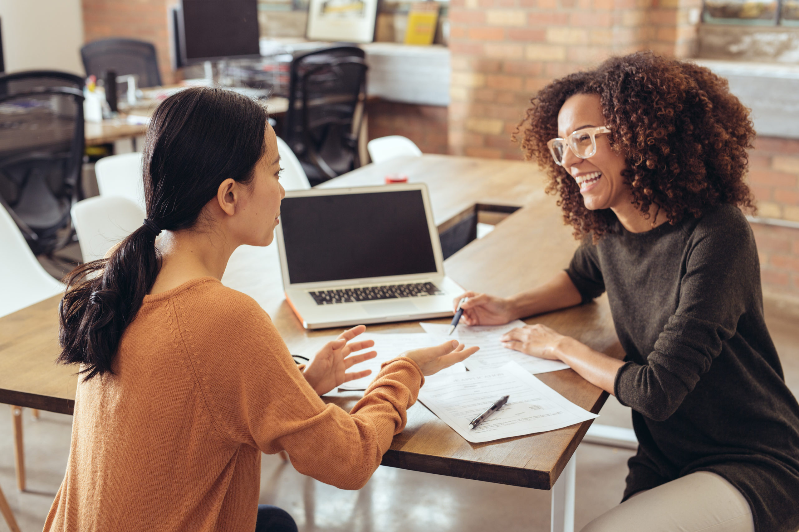 Two female colleagues discussing the new marketing strategy