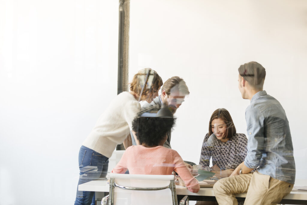 Group of business colleagues discussing job architecture at conference table in board room