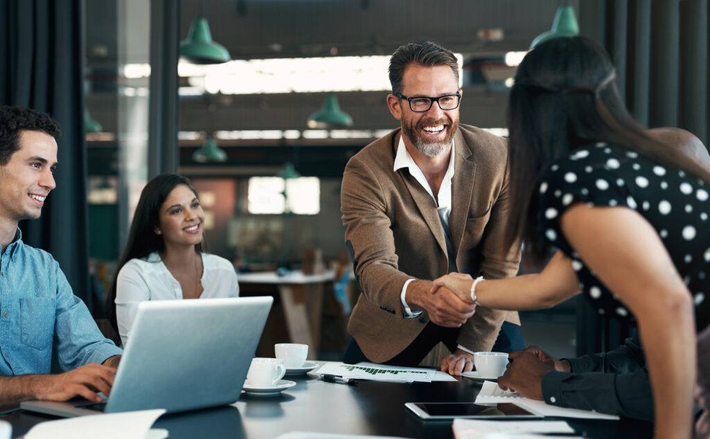 Business people meeting and handshake for partnership, b2b contract deal or woman inclusion promotion. Corporate team, manager shaking hands in office for commitment, onboarding or client negotiation