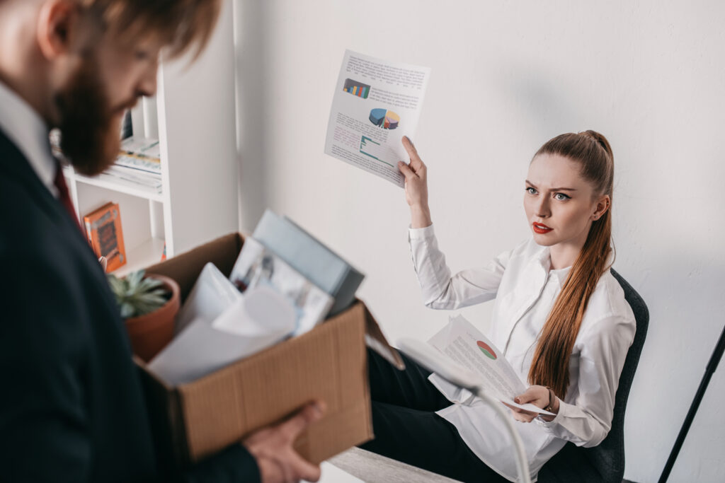 A picture of the traditional view of HR with a young man being fired by an HR executive. As opposed to 2024 SME Success Strategies: The New Essential Role of HR